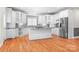 Bright kitchen with white cabinets, granite countertops, stainless steel appliances, and hardwood floors at 126 Emerald Dr, Mooresville, NC 28117