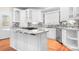 Modern kitchen with white cabinets, a marble countertop island, and stainless steel appliances at 126 Emerald Dr, Mooresville, NC 28117