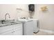 Laundry room with granite counter, sink, storage cabinets and modern washer and dryer at 126 Emerald Dr, Mooresville, NC 28117