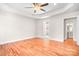 Spacious main bedroom featuring tray ceiling, hardwood floors, ensuite bathroom, and walk-in closet at 126 Emerald Dr, Mooresville, NC 28117