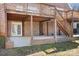 Covered patio with stairs leading up to the backyard deck at 126 Emerald Dr, Mooresville, NC 28117