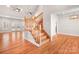 Spacious foyer featuring hardwood floors and a beautiful wooden staircase with landing at 126 Emerald Dr, Mooresville, NC 28117