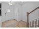 Inviting entryway with hardwood floors, a bright white door, and a staircase leading to the upper level at 14024 Felix Ln # 4, Charlotte, NC 28277