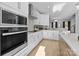 Modern kitchen features white cabinets, stainless appliances, and an open layout into the living space at 14024 Felix Ln # 4, Charlotte, NC 28277
