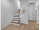 Clean, white staircase with wood accents and hardwood flooring, leading to upper levels of the home at 14024 Felix Ln # 4, Charlotte, NC 28277