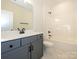 Updated bathroom with gray vanity, modern fixtures, and marble-look floors at 17025 Malone Ln, Mint Hill, NC 28227