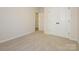 Neutral bedroom featuring light carpet, fresh paint, and double door closet at 17025 Malone Ln, Mint Hill, NC 28227