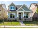 Charming craftsman-style home with a well-manicured lawn and a black metal fence at 17025 Malone Ln, Mint Hill, NC 28227