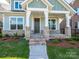 Inviting front porch with brick supports and a modern, covered entryway at 17025 Malone Ln, Mint Hill, NC 28227