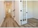 Inviting hallway featuring wood-look floors and white trim and doors at 17025 Malone Ln, Mint Hill, NC 28227