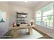 Bright home office features a wooden desk with metal shelving and a large window at 17025 Malone Ln, Mint Hill, NC 28227