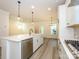 Open concept kitchen with a large island, stainless steel appliances, and hardwood floors at 17025 Malone Ln, Mint Hill, NC 28227