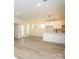 Open-concept living area with hardwood flooring, natural lighting, and kitchen view at 17025 Malone Ln, Mint Hill, NC 28227
