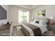 Cozy main bedroom featuring a large window, comfortable bedding, and a decorative painting at 17025 Malone Ln, Mint Hill, NC 28227