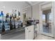 Elegant home bar area with mirrored backsplash and outdoor access at 18432 Harbor Light Blvd, Cornelius, NC 28031