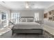 Comfortable bedroom with large windows, shutters, a ceiling fan, and a neutral color scheme at 18432 Harbor Light Blvd, Cornelius, NC 28031
