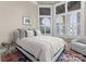 Cozy bedroom with large bay windows, shutters, and a comfortable bed with plush pillows at 18432 Harbor Light Blvd, Cornelius, NC 28031