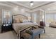 Elegant main bedroom featuring a large bed, bedside tables, bench, and plenty of natural light at 18432 Harbor Light Blvd, Cornelius, NC 28031