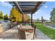 Charming outdoor dining area with a built-in grill, stone accents, and views of the lake at 18432 Harbor Light Blvd, Cornelius, NC 28031
