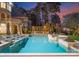 Stunning pool with a hot tub, lounge seating, and beautiful landscaping complements this gorgeous waterfront estate at 18432 Harbor Light Blvd, Cornelius, NC 28031
