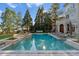 Well-maintained pool with pristine landscaping, hot tub, outdoor pergola, and backyard access to a main house at 18432 Harbor Light Blvd, Cornelius, NC 28031