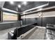 Home theater with tiered seating, large screen, and sophisticated sound system for immersive entertainment at 18432 Harbor Light Blvd, Cornelius, NC 28031