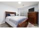 Bedroom featuring a wooden bed frame, chest of drawers, and a window with blinds at 211 Heritage Blvd # 108, Fort Mill, SC 29715