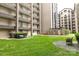 Back exterior of condo building with green space and mature plants at 211 Heritage Blvd # 108, Fort Mill, SC 29715