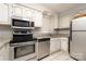 Kitchen featuring stainless steel appliances and granite countertops with white cabinets and a window at 211 Heritage Blvd # 108, Fort Mill, SC 29715