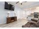 Cozy living room open to the kitchen featuring a ceiling fan, vinyl floors, neutral paint and comfortable sofa at 211 Heritage Blvd # 108, Fort Mill, SC 29715