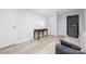 Living room with light floors and a gray couch next to a dark wood desk with a lamp at 211 Heritage Blvd # 108, Fort Mill, SC 29715