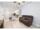 Cozy living room open to the kitchen featuring a ceiling fan, vinyl floors, neutral paint and comfortable sofa at 211 Heritage Blvd # 108, Fort Mill, SC 29715