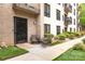 Cozy condo patio with seating area, brick facade, and garden views at 211 Heritage Blvd # 108, Fort Mill, SC 29715