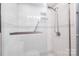 Tiled shower features updated fixtures, grab bar and patterned accent tiling at 211 Heritage Blvd # 108, Fort Mill, SC 29715