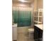 Clean bathroom featuring a shower with a green curtain, and a vanity with storage at 247 Damask Dr, Lancaster, SC 29720