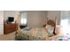 Bedroom with wooden bed frame, dresser, and shuttered window for natural light at 247 Damask Dr, Lancaster, SC 29720