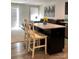 Open-concept living room with comfortable seating and kitchen island with stools at 247 Damask Dr, Lancaster, SC 29720