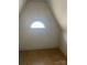 A small attic space with a window and slanted ceiling at 3045 Woodleaf Rd, Salisbury, NC 28147