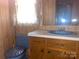 Bathroom featuring wood panel walls and a sink with storage beneath at 3045 Woodleaf Rd, Salisbury, NC 28147