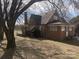 Quaint brick home featuring a covered porch and mature trees at 3045 Woodleaf Rd, Salisbury, NC 28147