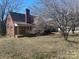 Image shows the exterior of a brick house with a chimney and yard at 3045 Woodleaf Rd, Salisbury, NC 28147