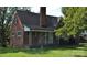 Charming brick home featuring a covered front porch and mature trees at 3045 Woodleaf Rd, Salisbury, NC 28147