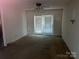 Living room featuring a ceiling fan and a glass door with vertical blinds for natural light at 3045 Woodleaf Rd, Salisbury, NC 28147
