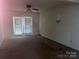 Living room featuring a ceiling fan and a glass door with vertical blinds for natural light at 3045 Woodleaf Rd, Salisbury, NC 28147