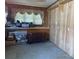 Room featuring wood panel walls and a window with floral pattern curtains at 3045 Woodleaf Rd, Salisbury, NC 28147
