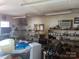 A well-lit storage room with ample shelving, a small refrigerator, and an air conditioner at 3045 Woodleaf Rd, Salisbury, NC 28147