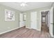 A spacious bedroom with neutral paint, ceiling fan and hardwood floors offers closet space at 333 S Eastway Dr, Troutman, NC 28166