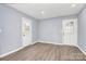 An airy bedroom with neutral paint, recessed lighting and hardwood floors is move-in ready at 333 S Eastway Dr, Troutman, NC 28166