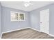 Inviting bedroom with hardwood floors, a ceiling fan and a light, neutral paint color at 333 S Eastway Dr, Troutman, NC 28166