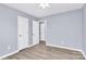 A spacious bedroom with neutral paint, ceiling fan and hardwood floors offers closet space at 333 S Eastway Dr, Troutman, NC 28166